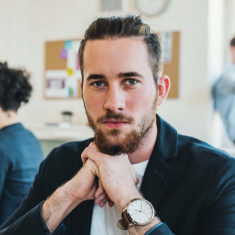 Testimonials 4 a portrait of young businessman with colleagues in HZKUL3B